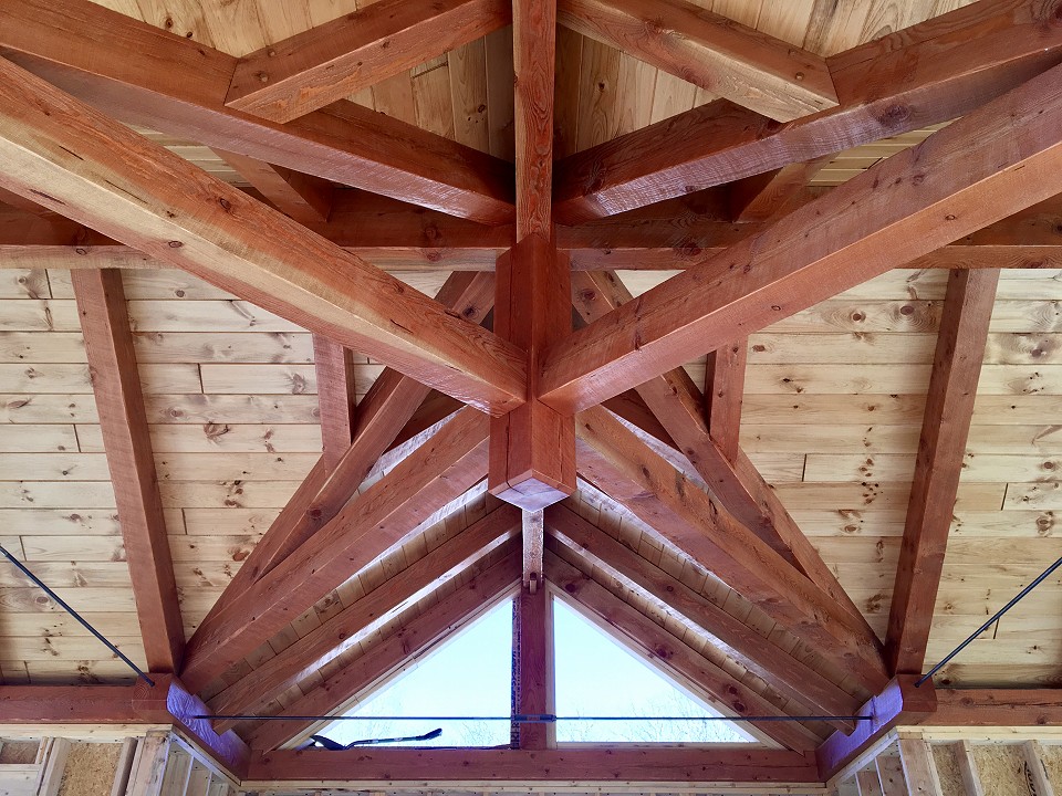 Interior View Were Multiple Members Meet Supported By Scissor Trusses And Steel Rods